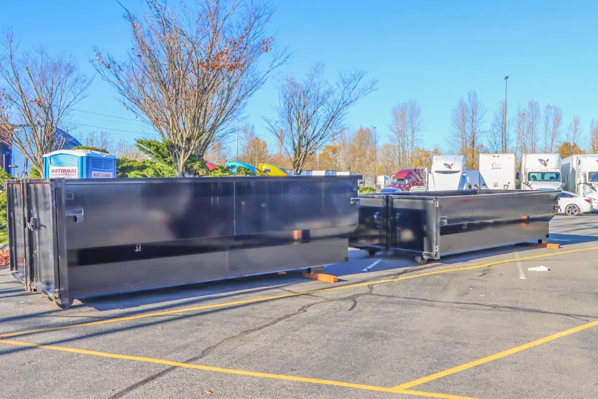 Professional dumpster rental service with roll-off container on residential driveway in Rowlett